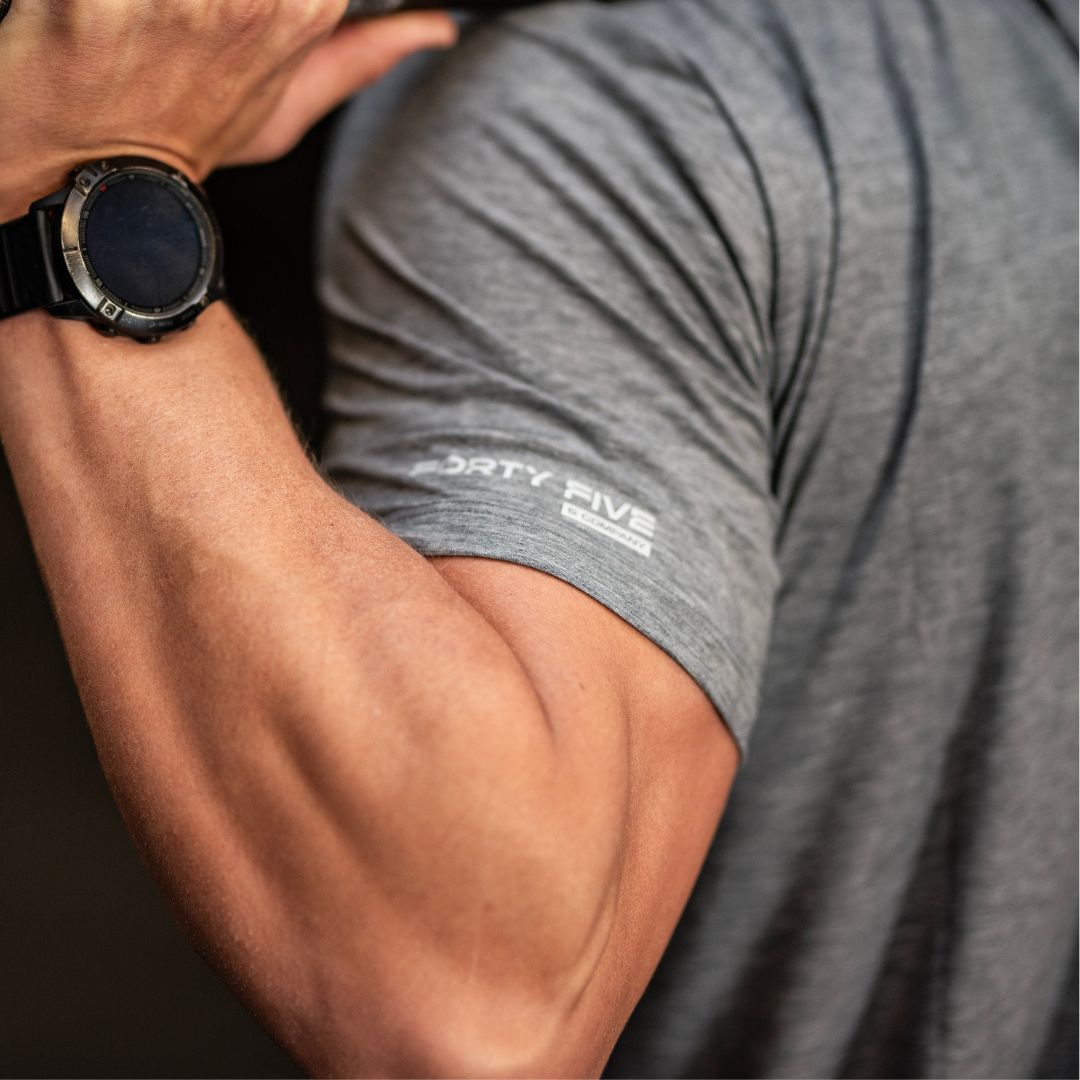 Person wearing a gray t-shirt with 'Forty Five' branding and a smartwatch on wrist.
