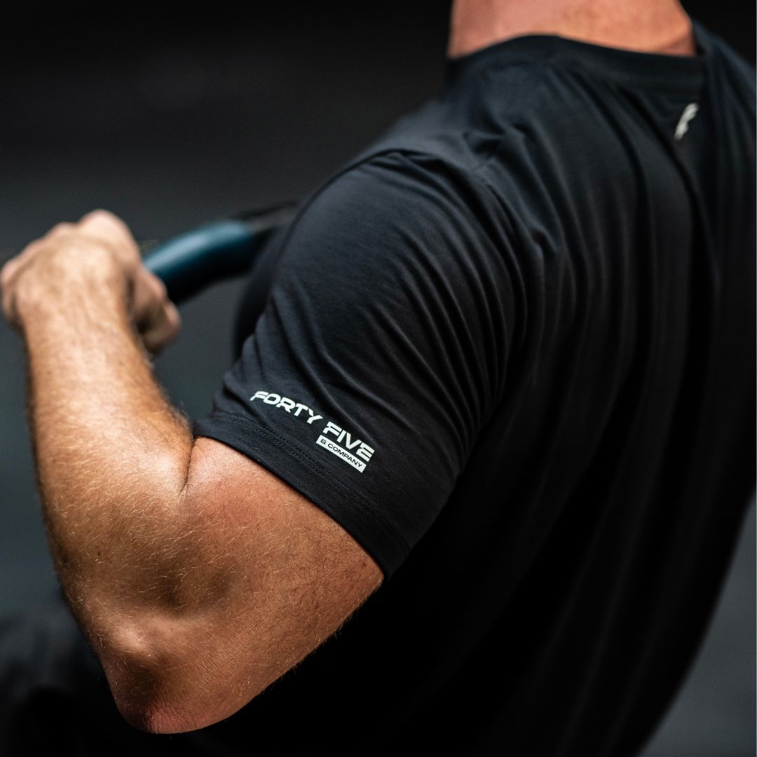 Person wearing a black sleeve with 'Forty Five' branding on an arm.