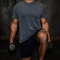 Person holding dumbbells against a dark background