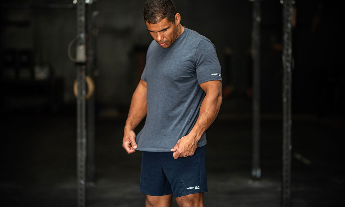 Man wearing a blue athletic outfit in a gym setting